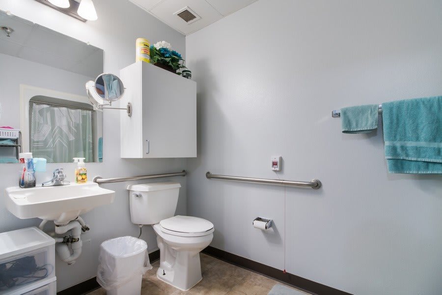 A clean and organized bathroom with accessibility features.