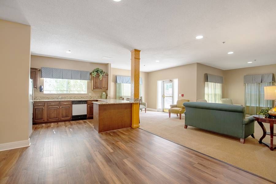 A spacious open floor plan featuring a modern kitchen and living area with ample natural light.