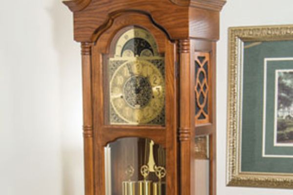 A classic wooden grandfather clock with intricate details and a visible pendulum.