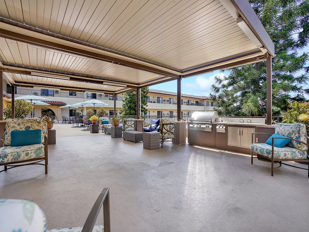 A spacious outdoor patio with comfortable seating and a covered area.