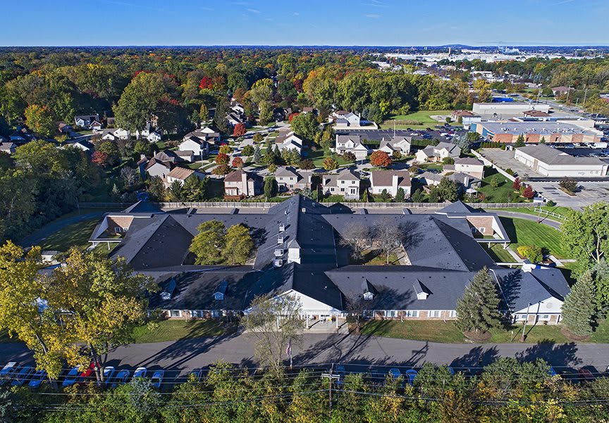 An aerial view of a suburban neighborhood with buildings and trees.