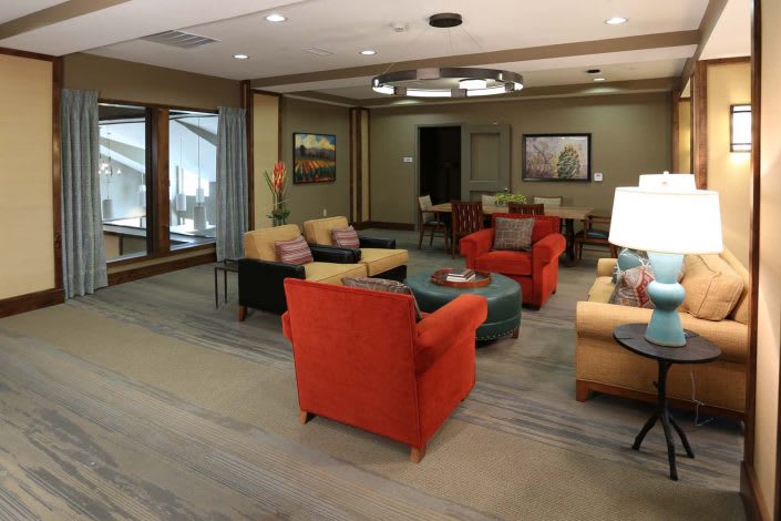 A cozy lobby area featuring colorful armchairs and a modern interior design.