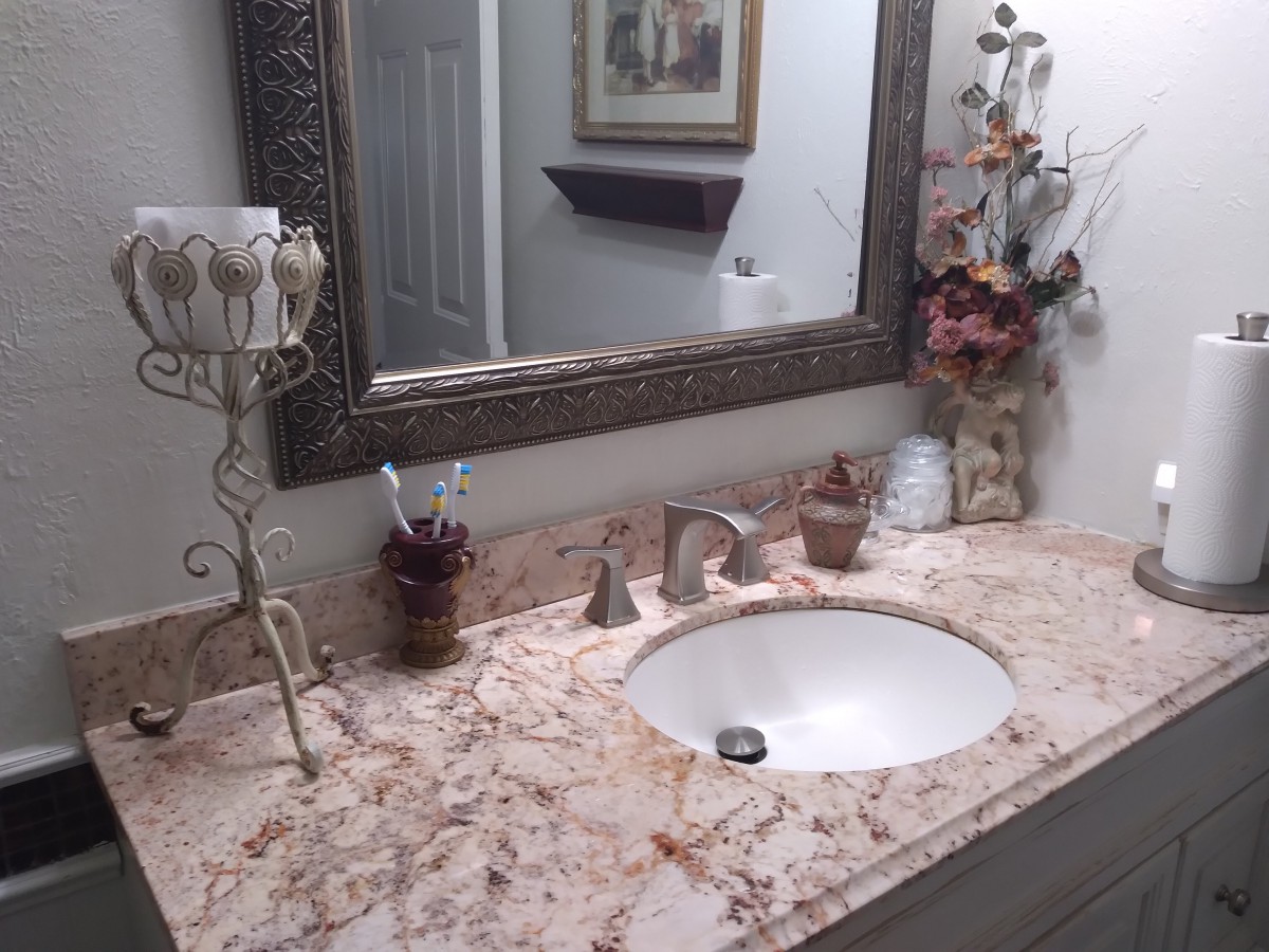 A stylish bathroom with a marble countertop and decorative elements.