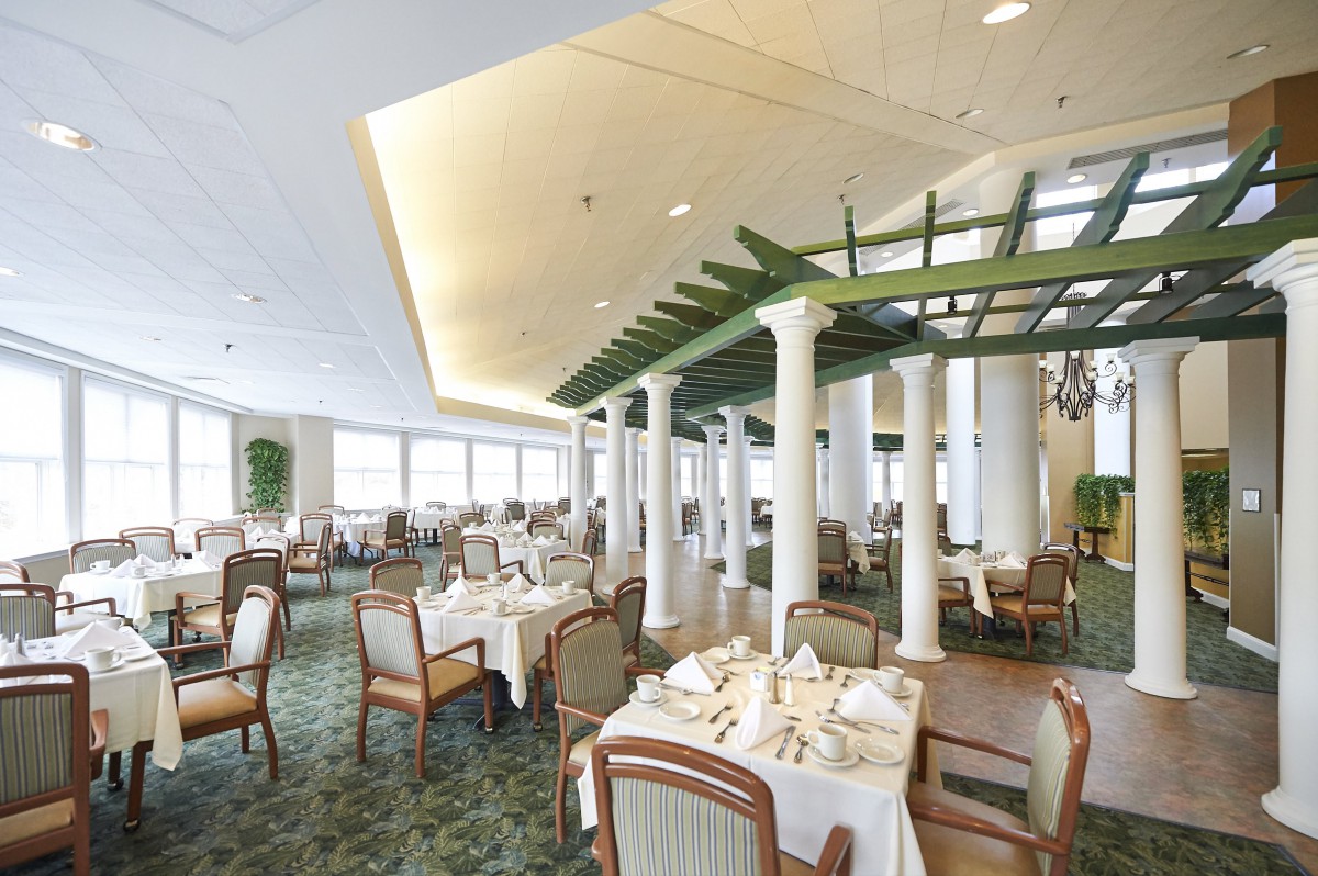 A spacious and elegantly decorated restaurant interior with neatly arranged tables and chairs.