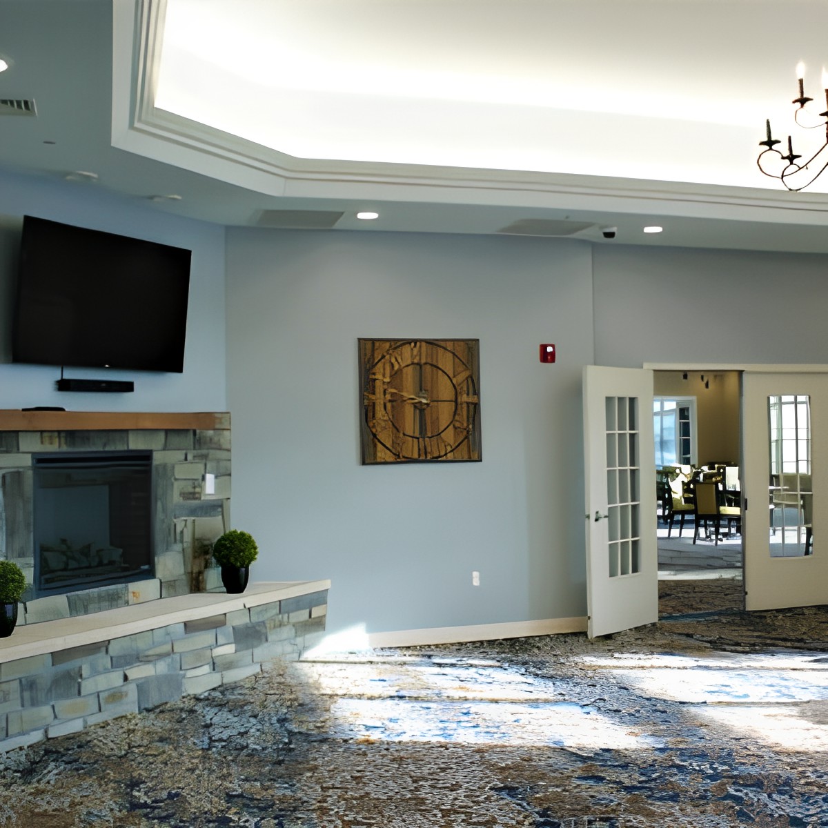A spacious living room interior with a fireplace, television, and elegant decor.
