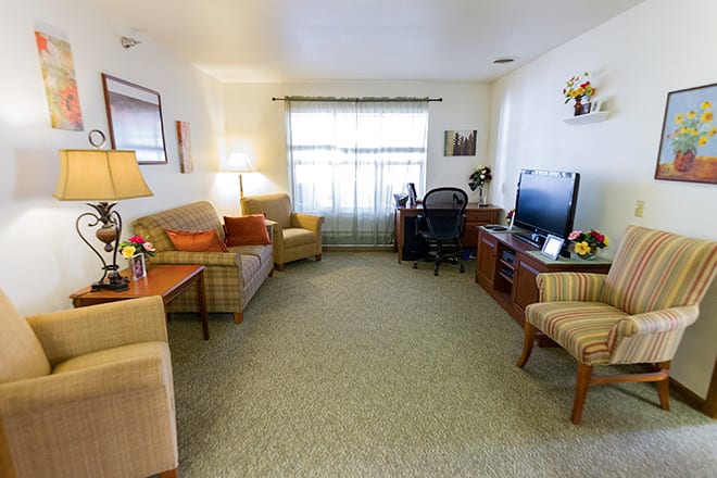 A cozy living room with comfortable seating and a television.