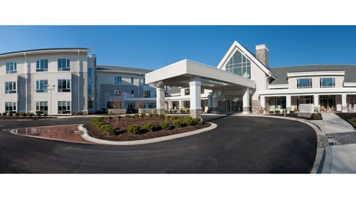 A modern hotel entrance featuring an inviting design and well-maintained landscaping.