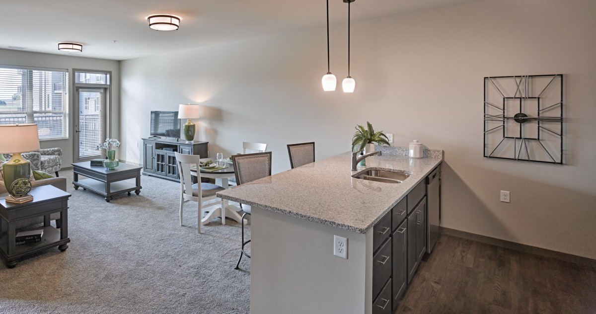 Modern open-concept kitchen and dining area with stylish lighting.