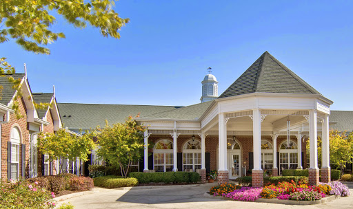 A charming residential building featuring elegant architecture and vibrant landscaping.