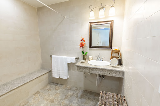 A neatly designed bathroom featuring a modern sink, mirror, and decorative elements.