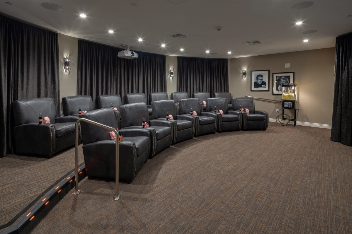 A luxurious home theater setup with comfortable seating and a large screen, ready for an immersive movie experience.