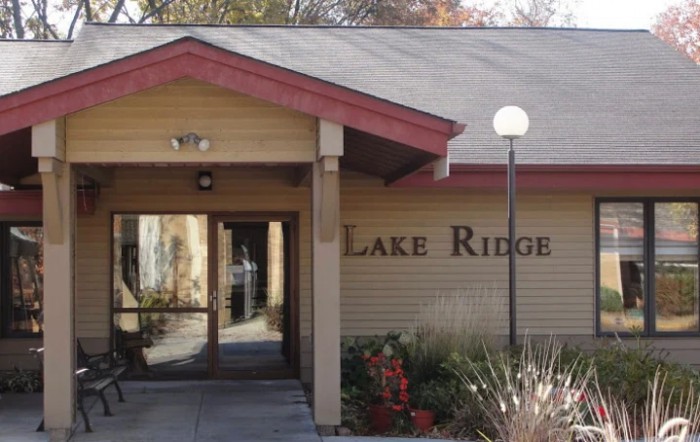 The entrance to a building named Lake Ridge, featuring its signage and surrounding exterior design.