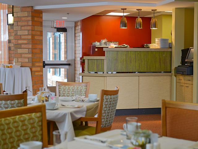 A cozy restaurant dining room with neatly arranged tables and chairs.