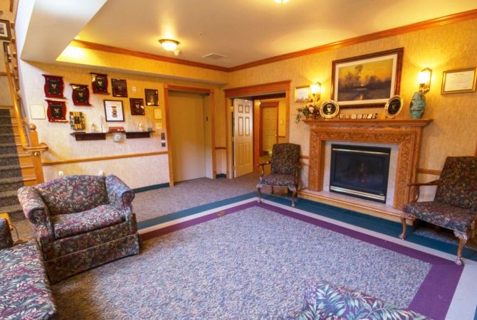A cozy living room featuring a fireplace, a comfortable seating area, and warm decor.