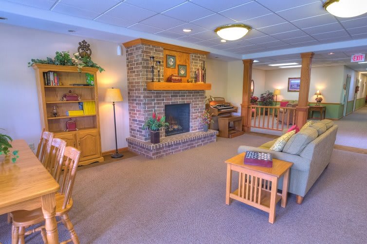 A cozy living room with a brick fireplace and comfortable seating.