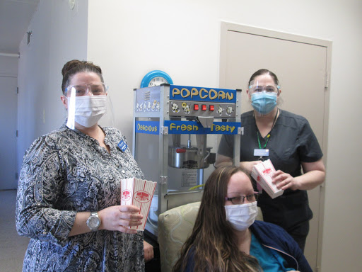 Healthcare staff enjoying a snack break with popcorn.