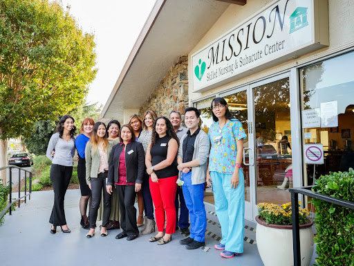 A dedicated team of healthcare professionals gathered outside the Mission Health and Wellness Center.
