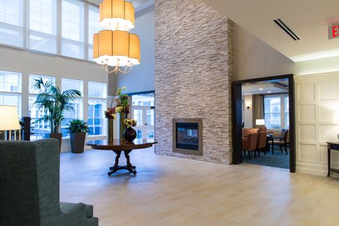 A modern lobby area featuring a fireplace and elegant decor.