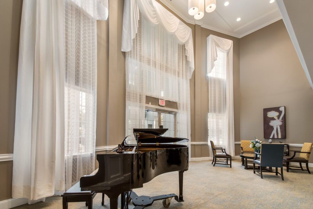 Spacious lobby with a grand piano and elegant decor.