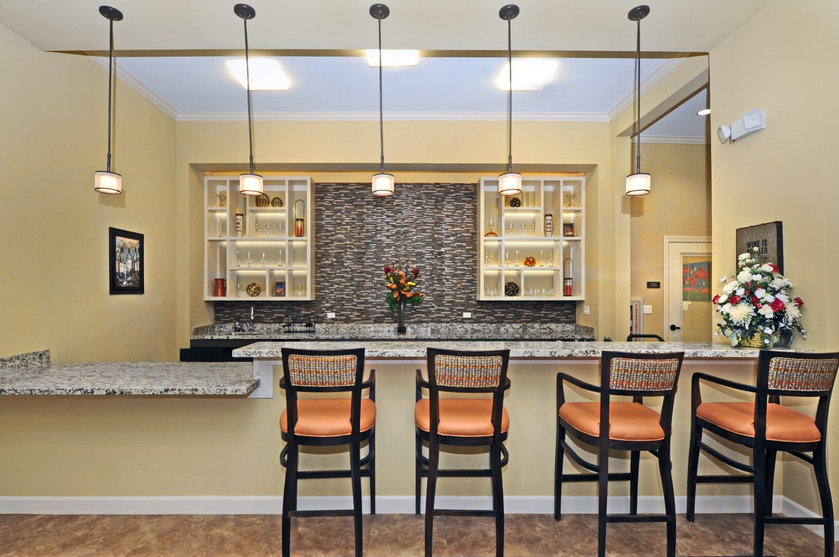 Modern kitchen with bar seating and stylish pendant lighting.