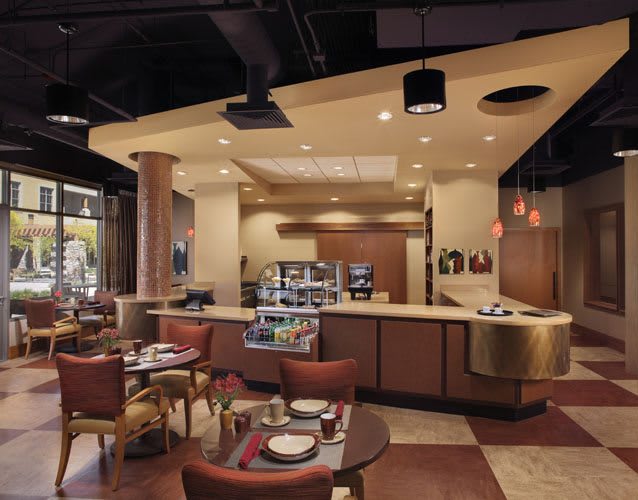 A modern restaurant interior with neatly arranged tables and chairs, featuring a cozy atmosphere.