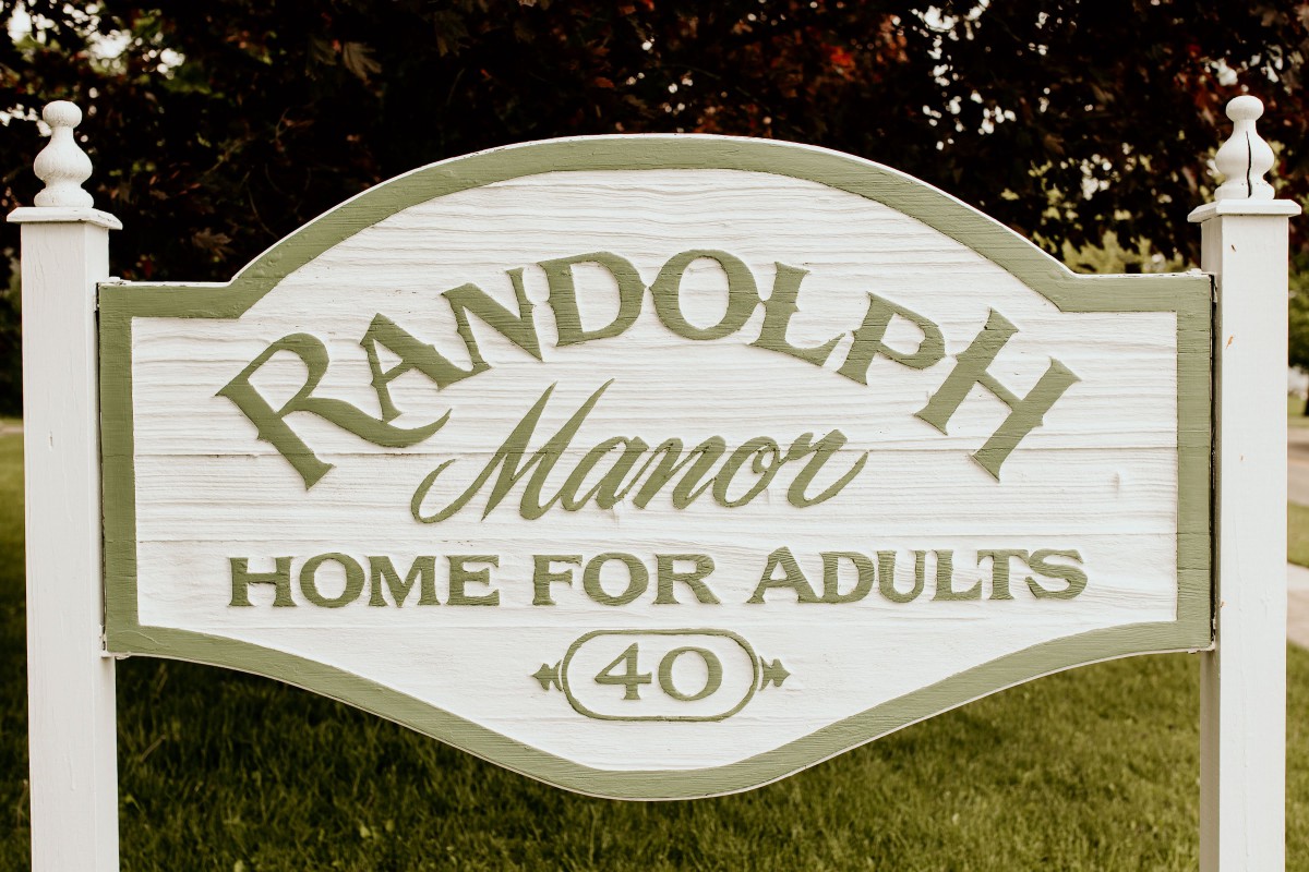 A sign for Randolph Manor, a home for adults.
