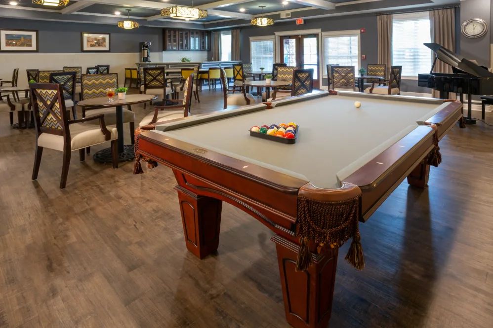 A cozy game room featuring a pool table and seating area.