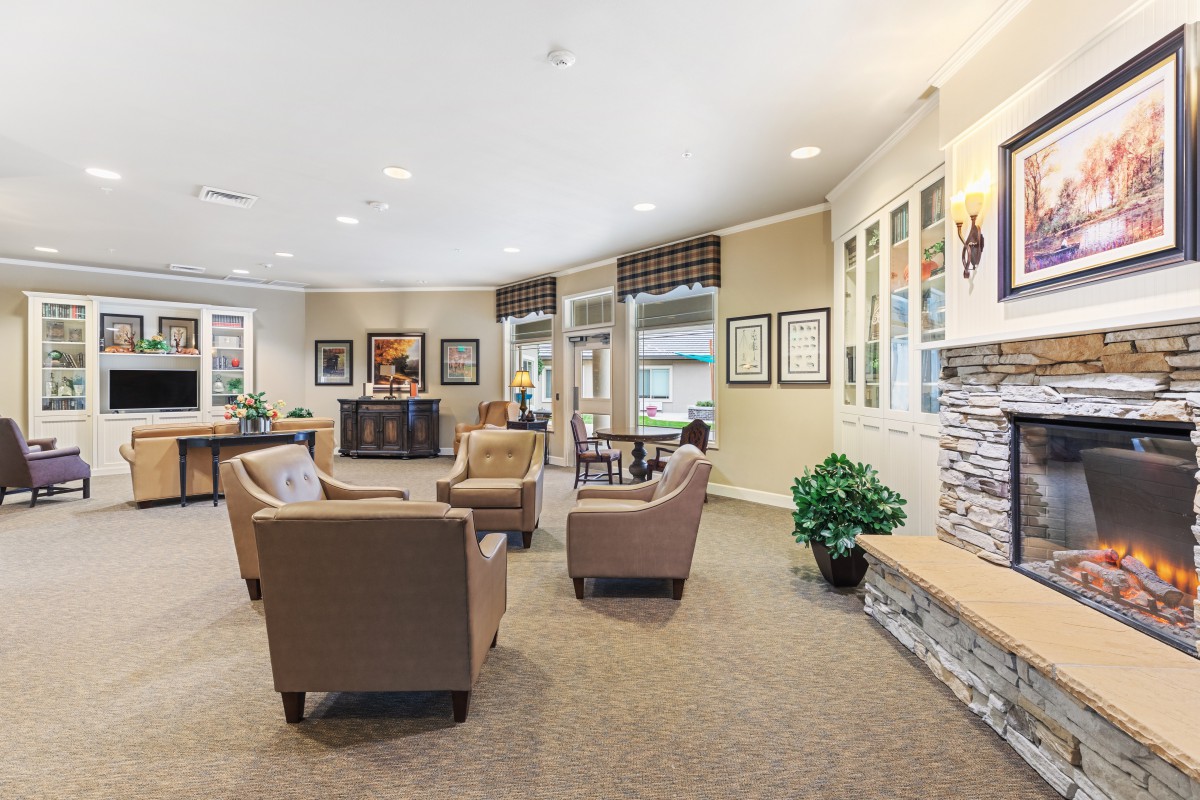 A cozy and well-decorated waiting area with comfortable seating and artwork.