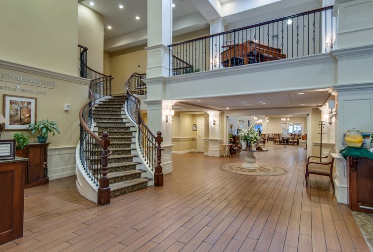 An elegant hotel lobby with a grand staircase and spacious design.