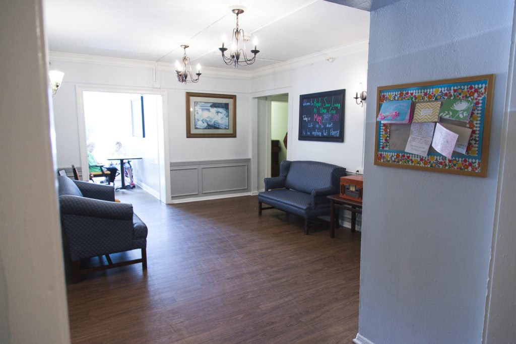 A well-lit waiting room with comfortable seating and elegant decor.