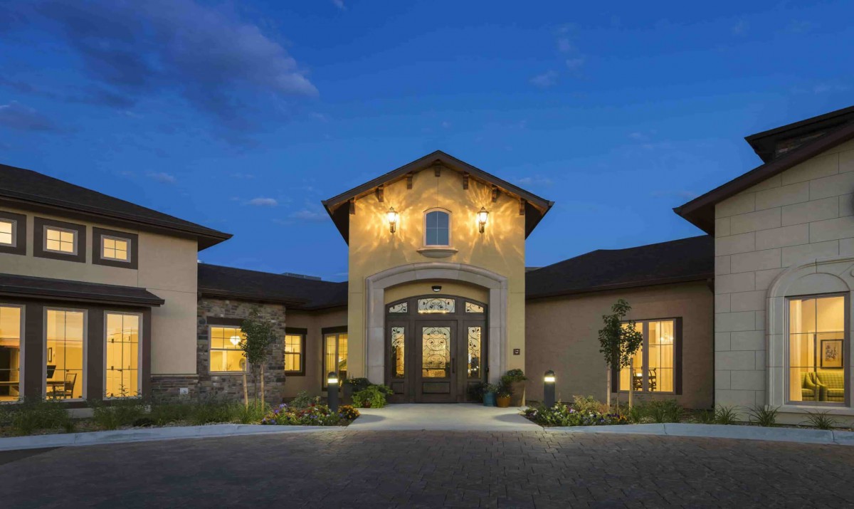 Elegant house with evening lights and a welcoming entrance.
