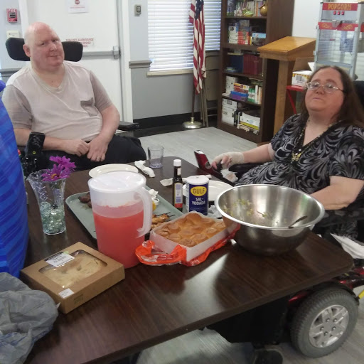 Two individuals enjoying a relaxed moment together in a community space.