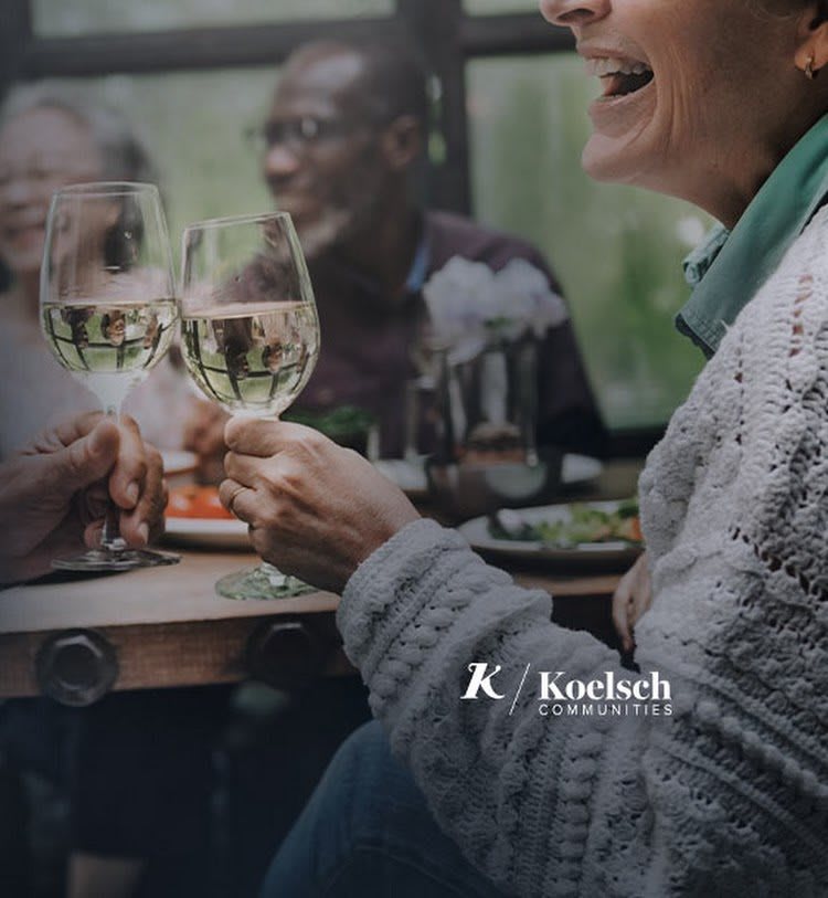 Friends enjoying a celebratory meal with wine and laughter.