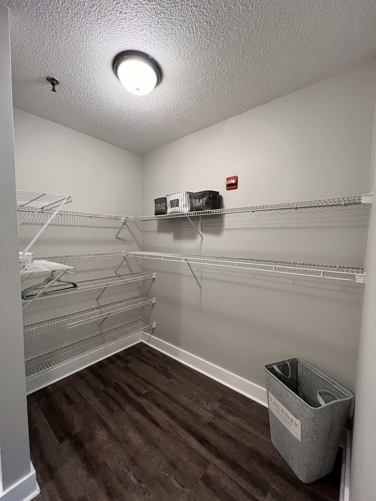 An empty closet with wire shelving installed along the walls.
