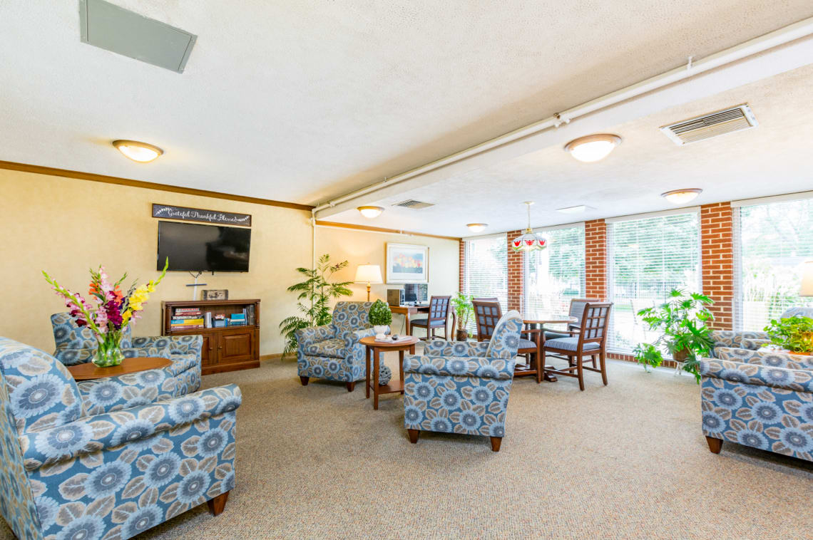 A cozy lounge area with comfortable seating and abundant natural light.