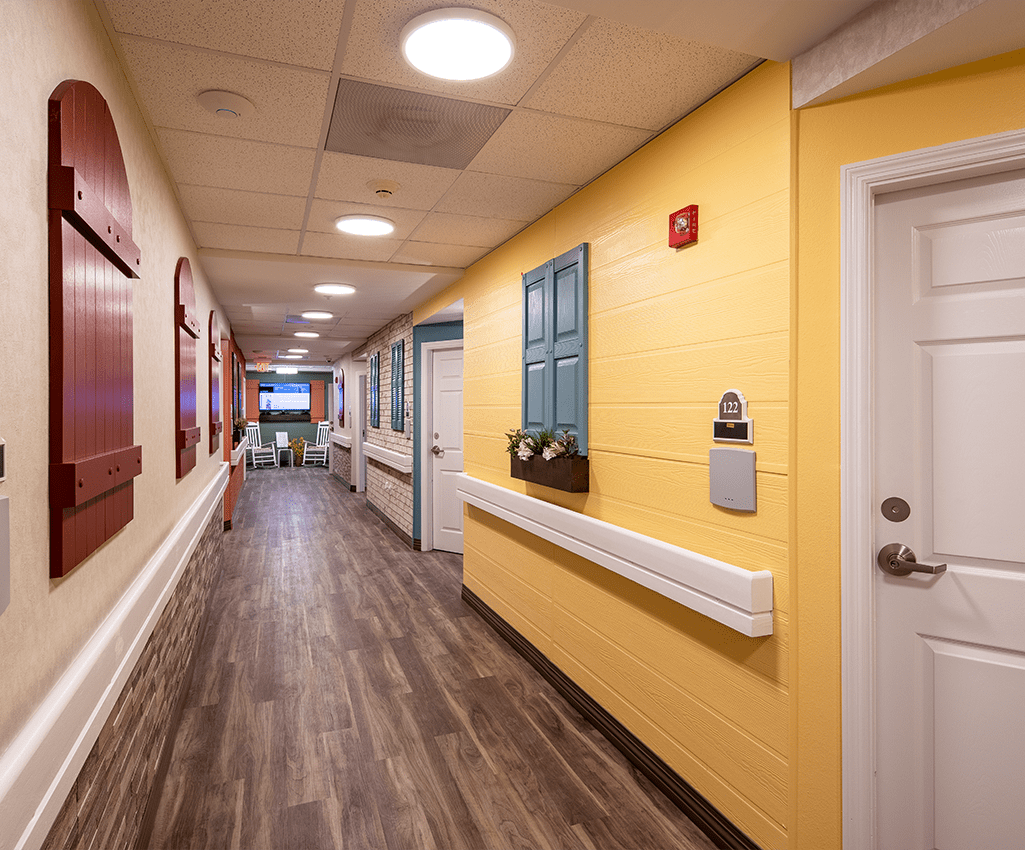 A brightly colored hallway with wooden flooring and decorative elements on the walls.