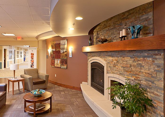 A cozy modern living room with a fireplace and comfortable seating.