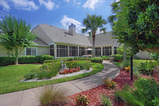 A beautiful residential home with a well-maintained garden and curved pathway.