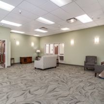 A spacious waiting room with comfortable seating and soft lighting.