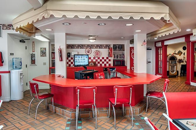 A retro-themed diner with red seating and checkered walls.