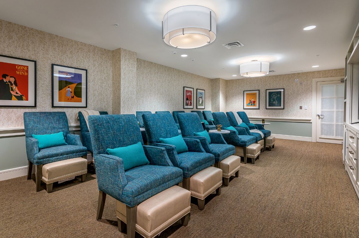 A modern relaxation area featuring comfortable spa chairs with footrests in a well-lit interior.