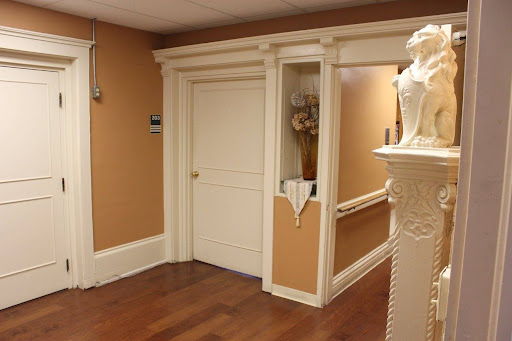 A well-decorated hallway featuring a closed door and elegant design elements.