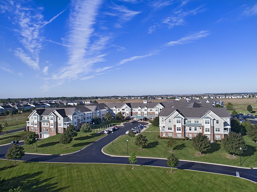 A suburban residential area with several apartment buildings under a clear blue sky.