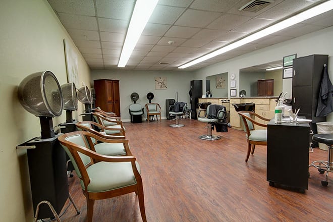 An interior view of a hair salon featuring chairs, mirrors, and other salon equipment.