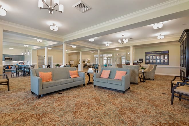 Bright and spacious living room with comfortable seating and elegant lighting.