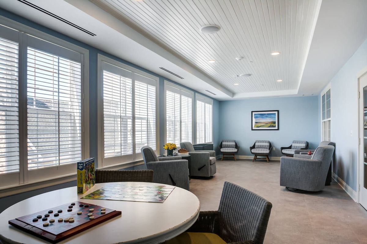 A well-lit waiting room with comfortable seating and large windows.