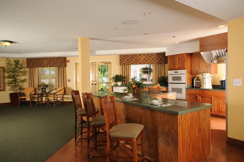 A modern kitchen with bar seating and open layout.