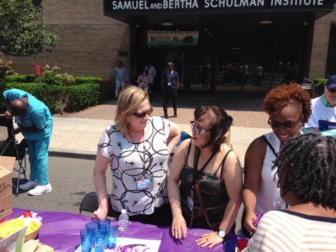Participants engaging in a community event outside the Samuel and Bertha Schulman Institute.