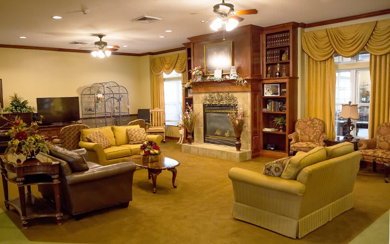 A warm and inviting living room featuring a fireplace, comfortable seating, and classic decor.