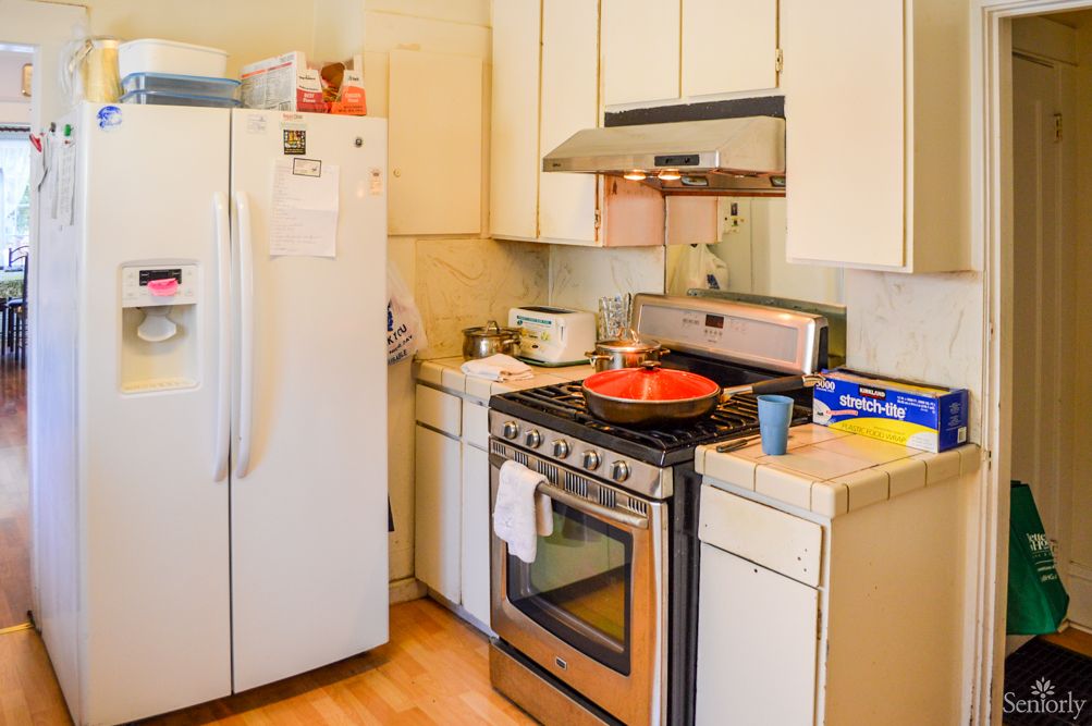 A home kitchen with a refrigerator, stove, and cabinetry.